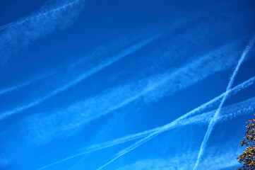 blue sky background with airplane traces