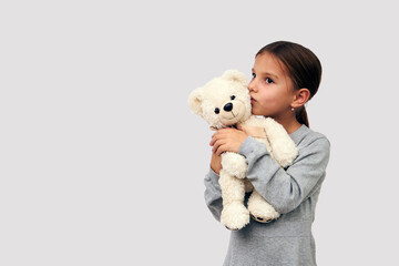 Portrait of little girl with white toy bear