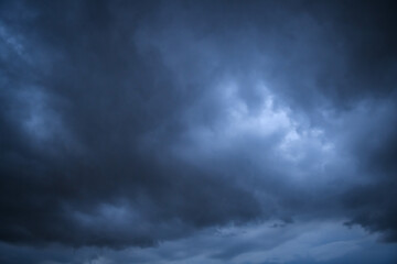 Storm clouds floating in a rainy day with natural light. Cloudscape scenery, overcast weather. White and grey clouds scenic nature environment background