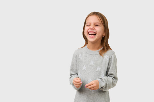 Cute little girl laughing on white background with copy space