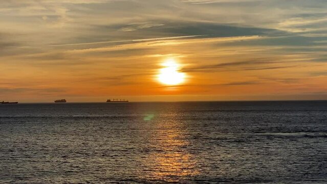 4k Big Sunset Over Ocean,Sunrise Time Lapse over some good waves. Some surfers enjoying the sea.
