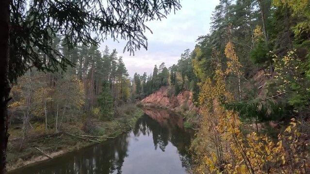 Nelku Red Sandstone Cliffs at the River Salaca in Skanaiskalns Nature Park in Mazsalaca in Latvia, Autumn Time. Sandstone Geological Formation