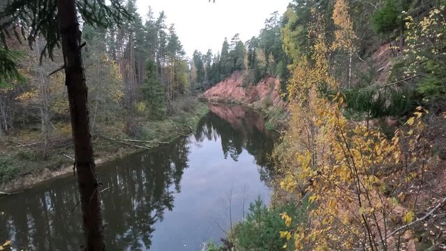 Nelku Red Sandstone Cliffs at the River Salaca in Skanaiskalns Nature Park in Mazsalaca in Latvia, Autumn Time. Sandstone Geological Formation
