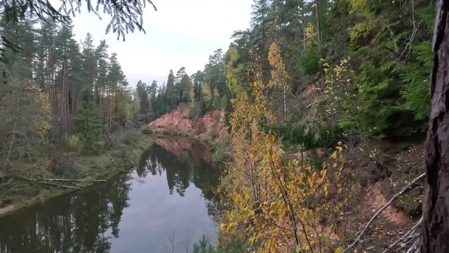 Nelku Red Sandstone Cliffs at the River Salaca in Skanaiskalns Nature Park in Mazsalaca in Latvia, Autumn Time. Sandstone Geological Formation