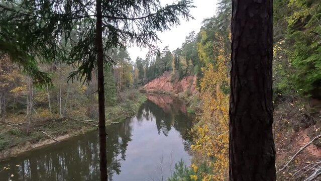 Nelku Red Sandstone Cliffs at the River Salaca in Skanaiskalns Nature Park in Mazsalaca in Latvia, Autumn Time. Sandstone Geological Formation