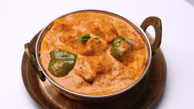 Kadai Paneer is a spicy, flavourful and delicious gravy dish made with  paneer, bell pepper, and onion in a freshly ground spice and served with  lachcha parantha and onion 