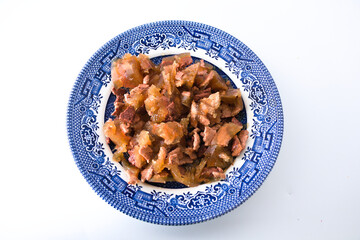 Food for cats on a china plate isolated