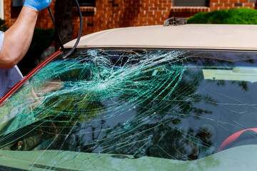 Automobile service special workers replacing windscreen near home an after accident