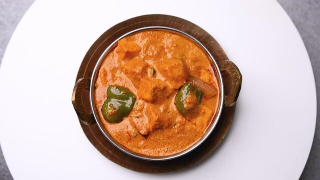 Kadai Paneer is a spicy, flavourful and delicious gravy dish made with  paneer, bell pepper, and onion in a freshly ground spice and served with  lachcha parantha and onion 