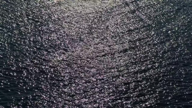 Night shiny glittering sea water background.