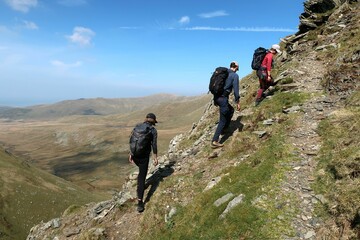 Scotland, Snowdonia. Hiking and climbing ridges through the wilderness during Spring time. Some...