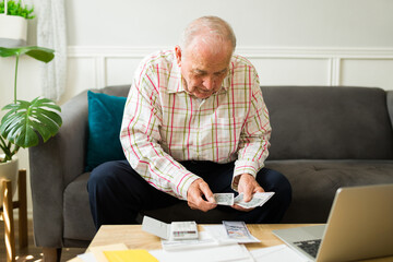 Smiling elderly man happy with his finances and pension