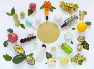 Fototapeta na wymiar Various types of vitamin anti-aging cosmetic products with natural fruit extracts on white background. Circular composition with empty space for text. Presentation of cosmetics. Flat lay, mock up