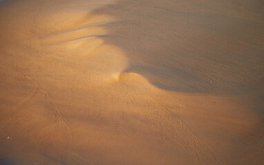 Bronze beach sand texture background, selective focus