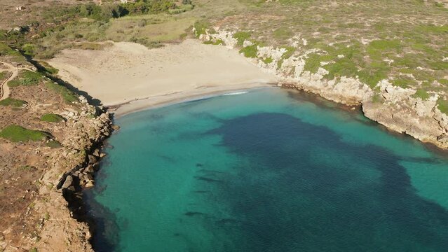 Aerial View Over Calamosche Beach With Turquoise Water In Italy - drone shot