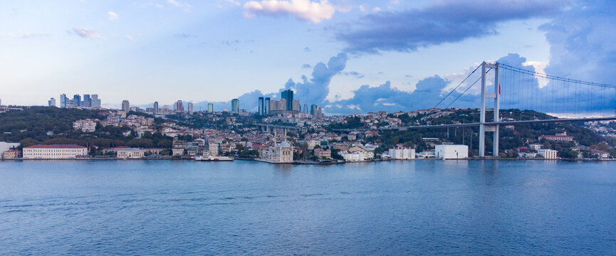 Panorama image Skyscrapers of istanbul behind the Bosphorous, financial district of Turkey next to a big bridge