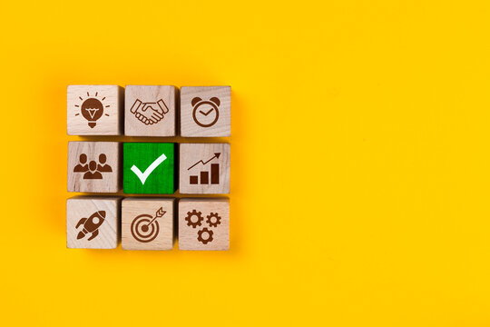 Business process management. Wooden blocks with icon business strategy on yellow background.