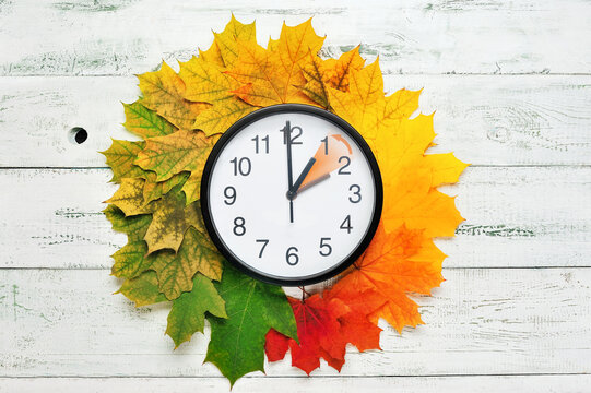 Fall Time Change Still Life With Maple Tree Foliage And Wall Clock