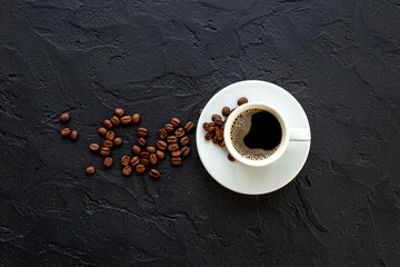 Black coffee - espresso - in white cup with coffee beans