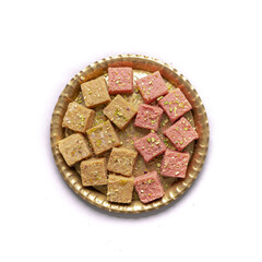 mix burfi or barfi in a plate top view - an indian traditional sweet or mithai in thali