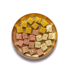 mix burfi or barfi in a plate top view - an indian traditional sweet or mithai in thali