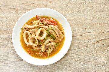 spicy fried squid with onion in egg and curry on plate
