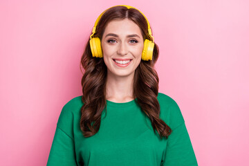 Photo of pleasant nice woman with wavy hairdo dressed green t-shirt headphones listen favorite...