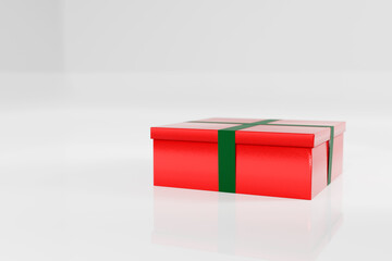 Red Christmas gift box present with green ribbon on white studio background, side position.