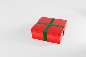 Red Christmas gift box present with green ribbon on white studio background. Quarter top view