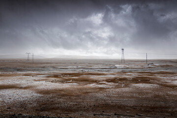 Snow-covered land in cloudy weather.