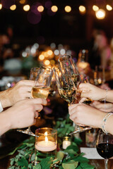 Hands of people with glasses on a holiday. Party, night, alcohol