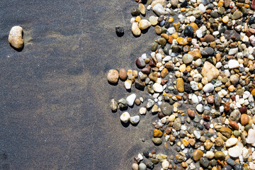 Colorful little stones washed by the shore at a Turkish beach near Çanakkale