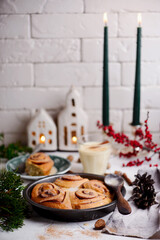 Egg nog cinnamon buns in christmas background