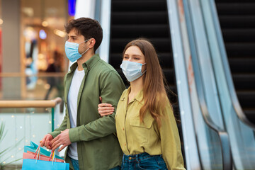 Spouses Shopping Walking With Bags Wearing Face Masks In Mall