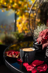 cappuccino outdoor on balcony table in autumn 