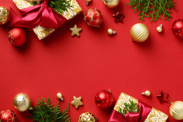 Red Christmas background with gift boxes, for branches, red and gold baubles. Christmas frame. Xmas greeting card, poster, cover template.