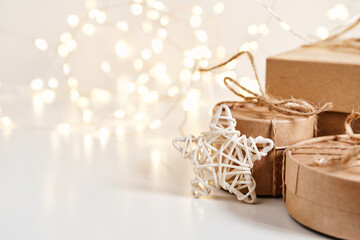 Christmas sustainable gift boxes with natural decor on shining bokeh background. Christmas zero...
