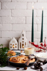 Egg nog cinnamon buns in christmas background