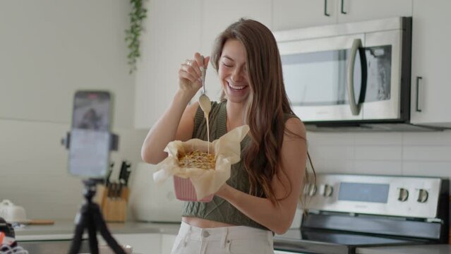 Girl influencer filming icing on baking recipe, vlogger