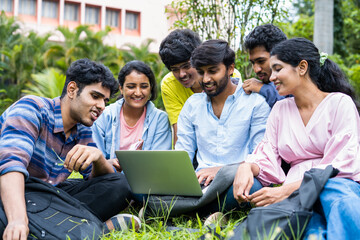 group of young students checking exam results or waiting for project approval on laptop at collage...