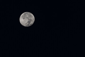 Full moon in the night sky with copy space