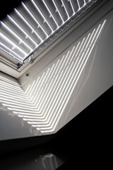 Obraz premium A side portrait of a velux roof window with a half open jalousie in it to keep the sun and warmth out or to keep the light from entering the room in the morning when people are still trying to sleep.