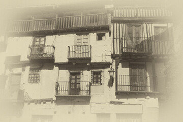 Historical, antique yellowed and faded photograph of the old Spanish town.