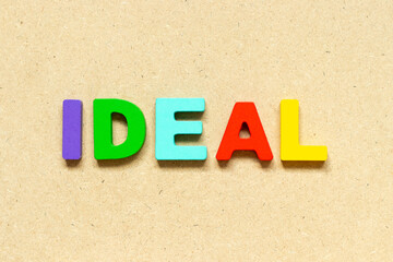 Color alphabet letter with word ideal on wood background