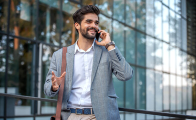Businessman making a phone call on the way to office. Business, lifestyle concept