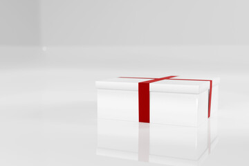 White glossy gift box with red ribbon on white high gloss background.