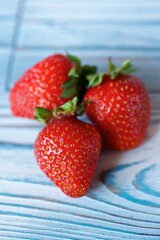 Fruit red ripe strawberries lies on a wooden surface. Ecological products grown in the garden