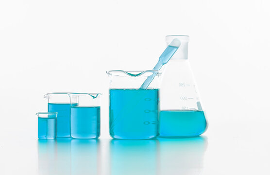 Set of chemical flasks with blue substance in lab