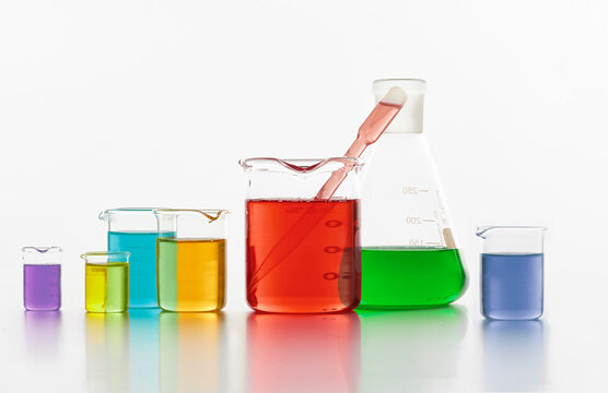 Set of laboratory test flasks with colorful liquids in white studio