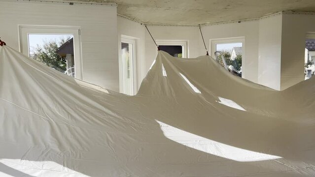 Stretch ceiling installation during home renovation.